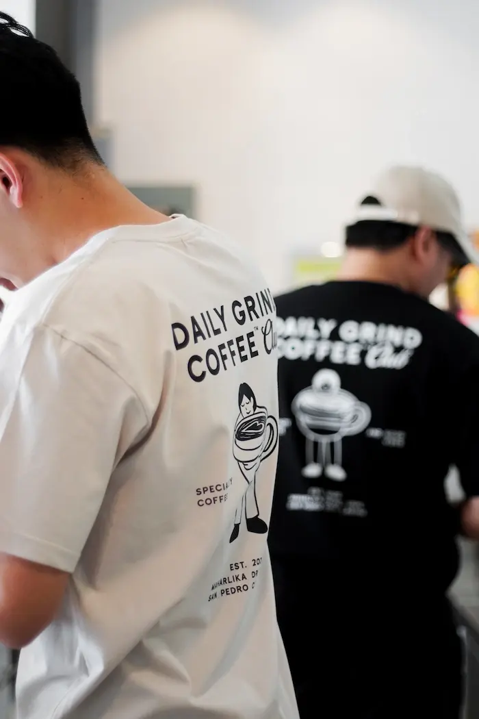 Daily Grind baristas wearing Coffee Club shirts