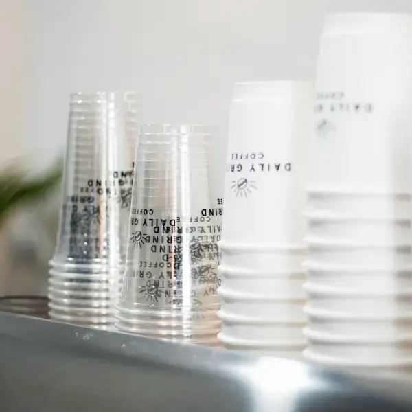Daily Grind cups lined up on the coffee cart